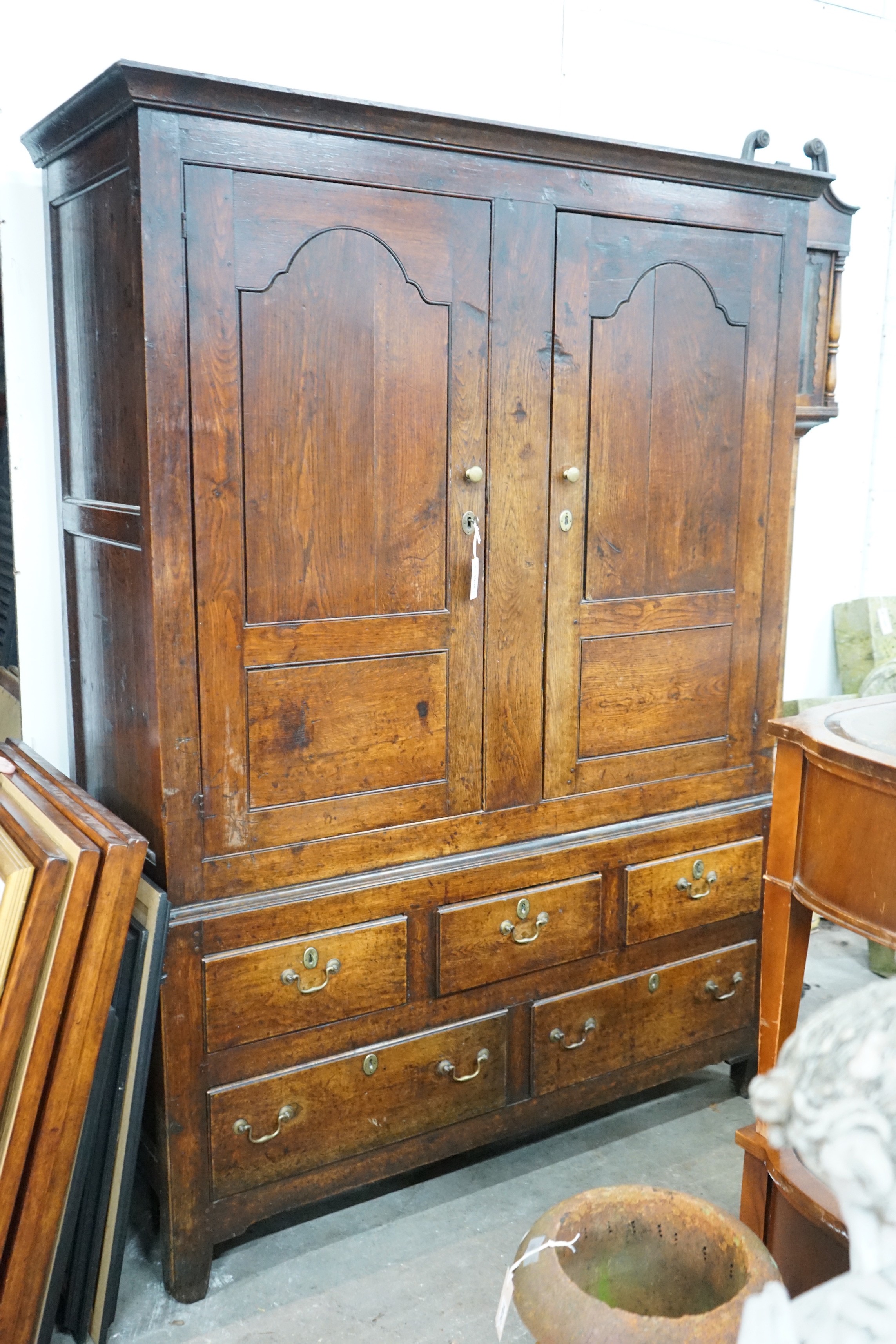 An 18th century oak hanging cupboard with later shelved interior, width 145cm, depth 56cm, height 199cm